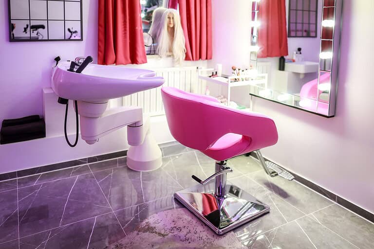 Al text: Modernes BDSM-Studio in München mit pinkem Stuhl und Stylingbereich, perfekt für erotische Experiences.